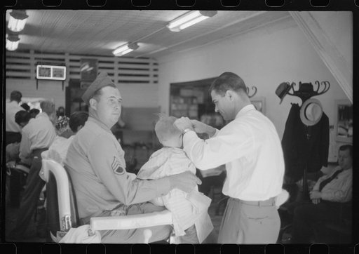 Untitled photo, possibly related to: Sergeant from Fort Benning getting his son's hair cut at a barber shop in Columbus, Georgia