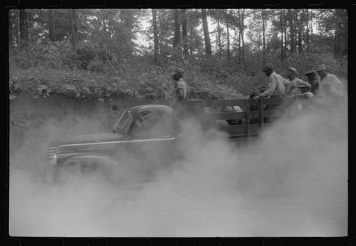 Workmen returning from powder plant on a dusty road near Childersburg, Alabama