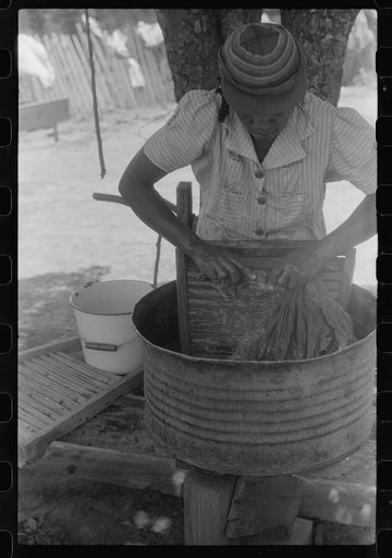 Untitled photo, possibly related to: Tenant farmer's wife washing clothes, Greene County, Georgia
