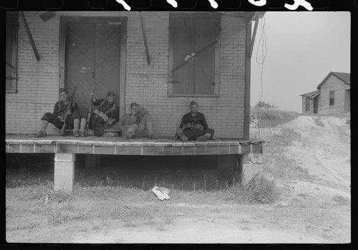 Untitled photo, possibly related to: Soldiers resting at an abandoned store during maneuvers in Caroline County, Virginia