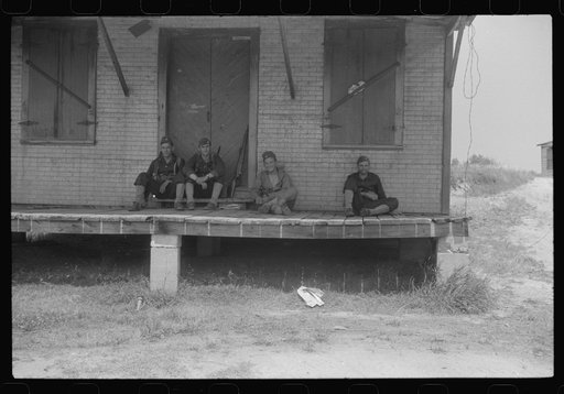 Soldiers resting at an abandoned store during maneuvers in Caroline County, Virginia