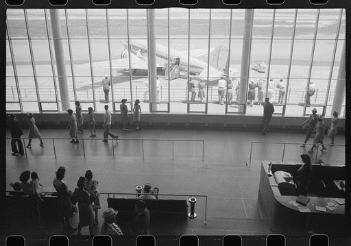 Untitled photo, possibly related to: Visitors watching planes through the window of the main waiting room at the municipal airport in Washington, D.C.