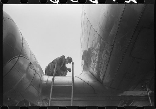 Checking the fuel in a plane on a rainy day at the municipal airport, Washington, D.C.