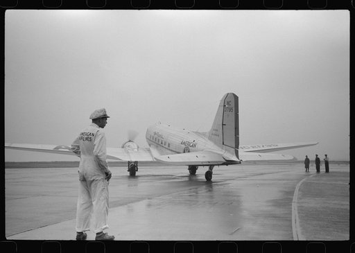 A plane taxiing toward the main runway on a rainy day at the municipal airport, Washington, D.C.