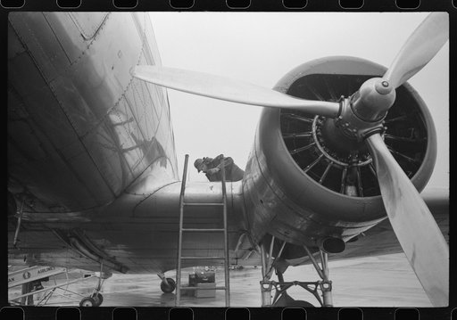 Checking the fuel on a plane at the municipal airport on a rainy day, Washington, D.C.