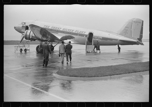 Passengers boarding a plane on a rainy day at the municipal airport in Washington, D.C.