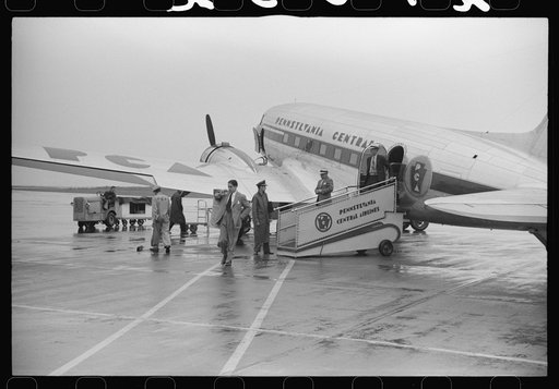 Untitled photo, possibly related to: Passengers boarding a plane on a rainy day at the municipal airport in Washington, D.C.
