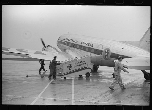 Untitled photo, possibly related to: Passengers boarding a plane on a rainy day at the municipal airport in Washington, D.C.