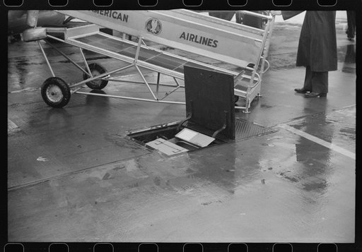 Untitled photo, possibly related to: Passengers boarding a plane on a rainy day at the municipal airport in Washington, D.C.