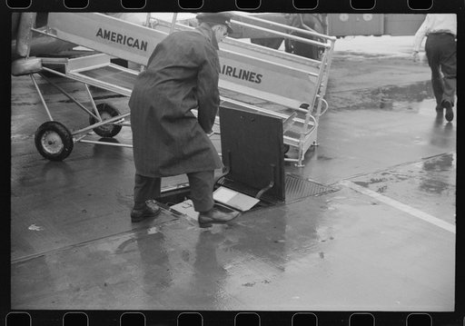Untitled photo, possibly related to: Passengers boarding a plane on a rainy day at the municipal airport in Washington, D.C.