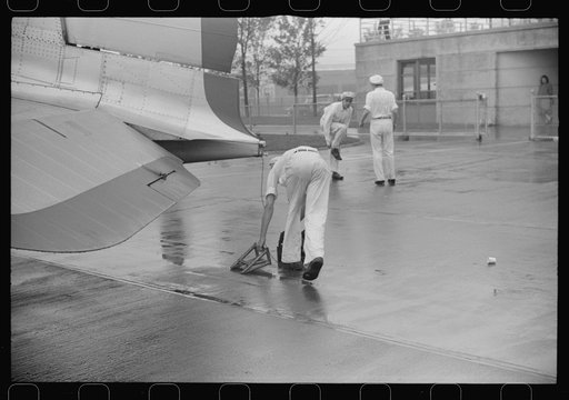Ground crew assistants leaving a plane to take off, Washington, D.C.