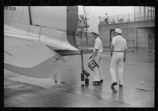 Ground crew assistants leaving a plane about to take off at the municipal airport in Washington, D.C.
