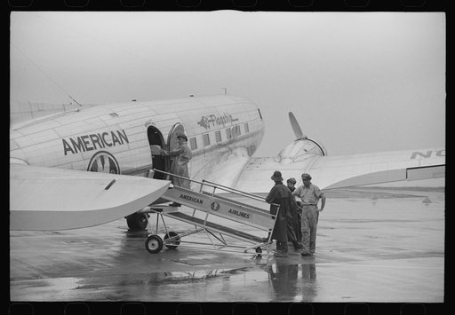 Ground crew getting a plane ready to take off on a rainy day at municipal airport in Washington, D.C.