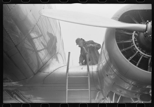 Untitled photo, possibly related to: Checking the fuel on a plane at the municipal airport on a rainy day, Washington, D.C.