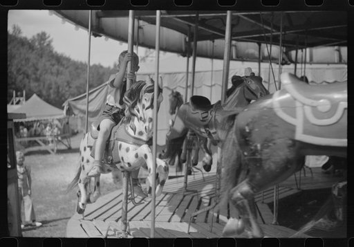 Untitled photo, possibly related to: On the merry-go-round of a small American Legion carnival just outside Bellows Falls, Vermont
