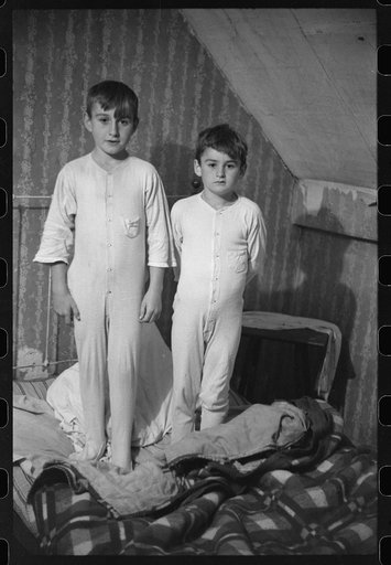 Untitled photo, possibly related to: Two of the Gaynor children going to bed on their farm near Fairfield, Vermont