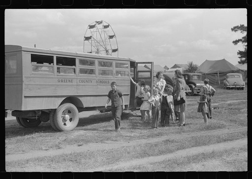 Schoolchildren getting off the bus for free day at the fair. Greene County, Georgia