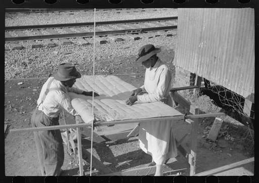 Making a quilt from surplus commodity cotton in Greensboro, Greene County, Georgia