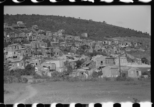 Untitled photo, possibly related to: Street in slum area in Ponce, Puerto Rico. The land on which the houses stand rented from between eighty cents and a dollar a lot per month. Each person built his own house. They had to pay twenty cents per month for water