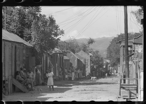 Untitled photo, possibly related to: Street in slum area in Ponce, Puerto Rico. The land on which the houses stand rented from between eighty cents and a dollar a lot per month. Each person built his own house. They had to pay twenty cents per month for water
