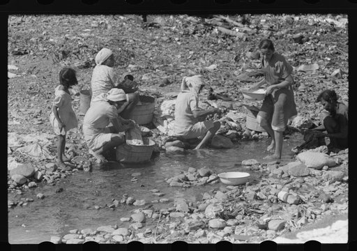 Washing clothes in the river near the slum area known as "El Machuelitto" in Ponce, Puerto Rico