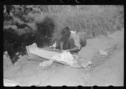 Using palm leaf as a wash tub on a farm near Manati, Puerto Rico