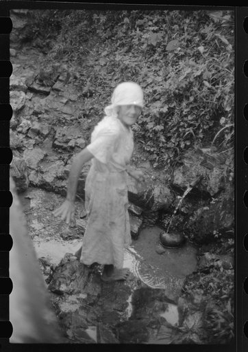 Untitled photo, possibly related to: Waiting at a spring to get water which is carried in gourdlike containers. Near Corozal, Puerto Rico
