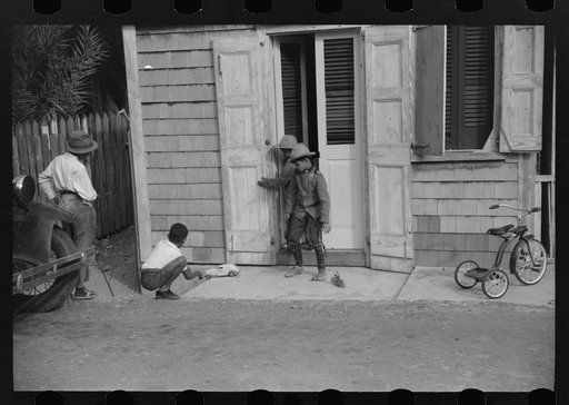Untitled photo, possibly related to: Children playing with their Christmas toys on a side street, Charlotte Amalie, St. Thomas, Virgin Islands