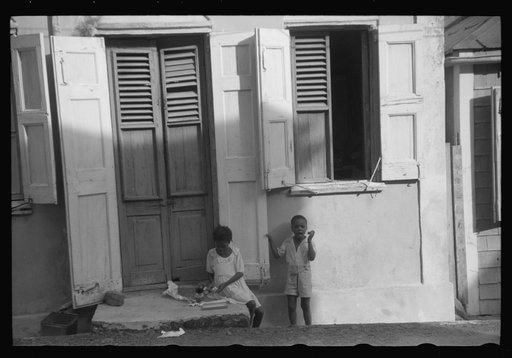 Untitled photo, possibly related to: Little girl playing with her Christmas presents on a side street in Charlotte Amalie, Virgin Islands