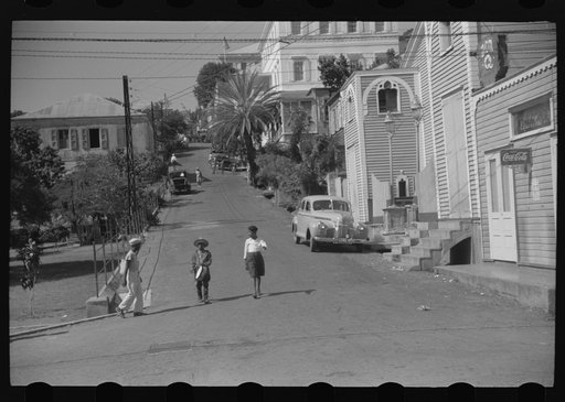 Charlotte Amalie, St. Thomas Island, Virgin Islands. Street scene. The boy in the center is dressed in a Christmas gift outfit