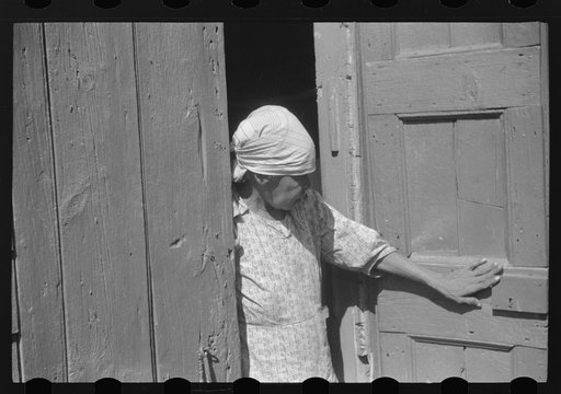 Charlotte Amalie, St. Thomas Island, Virgin Islands. Woman living in one of the bandbox houses