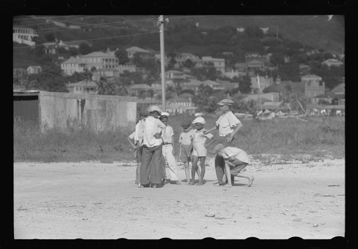 French Village, a small settlement on St. Thomas Island, Virgin Islands. Children playing marbles on an open lot