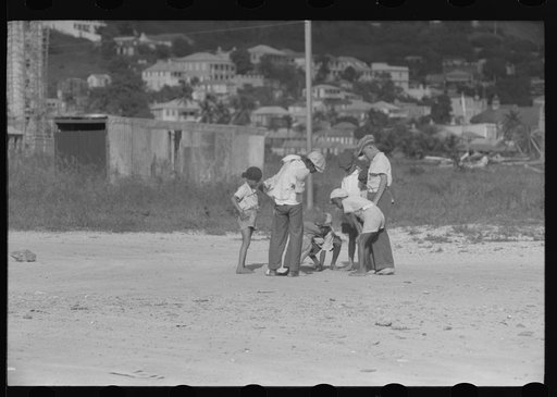 Untitled photo, possibly related to: French Village, a small settlement on St. Thomas Island, Virgin Islands. Children playing marbles on an open lot