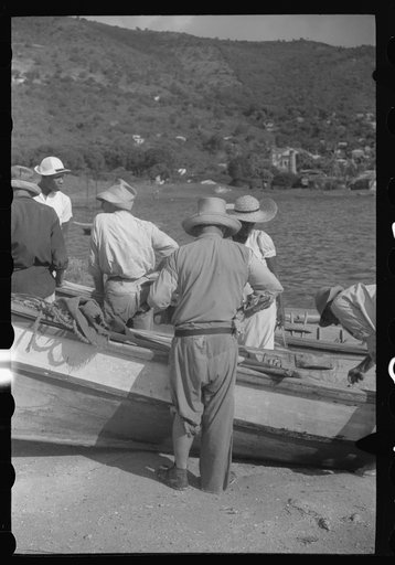 Untitled photo, possibly related to: French Village, a small settlement on St. Thomas Island, Virgin Islands. Fishermem bailing their boats after the day's catch