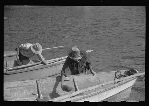 French Village, a small settlement on St. Thomas Island, Virgin Islands. Fishermem bailing their boats after the day's catch