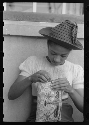 Charlotte Amalie, St. Thomas Island, Virgin Islands. Embroidering a handbag at the handicrafts cooperative