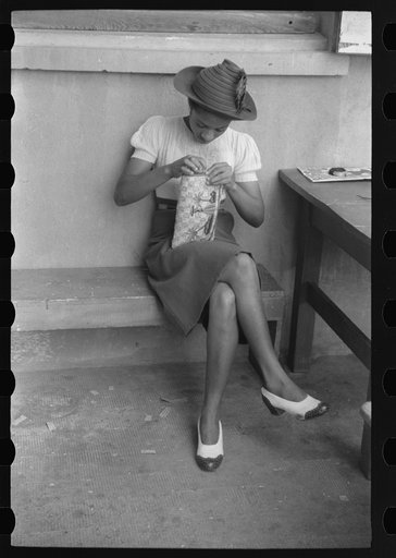 French Village, a small settlement on St. Thomas Island, Virgin Islands. Young girl embroidering a straw basket to be sold in the handicrafts cooperative in Charlotte Amalie
