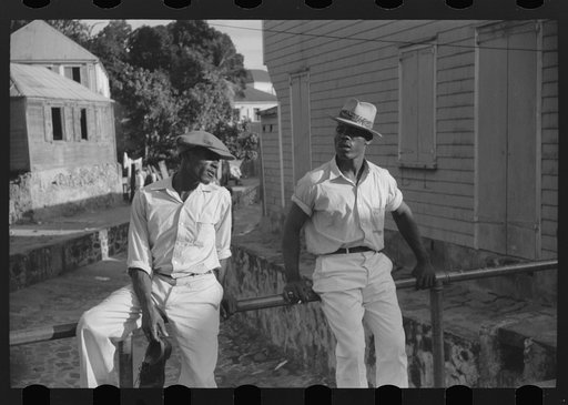 Charlotte Amalie, St. Thomas Island, Virgin Islands. Lounging on a bridge over an open sewer on a side street