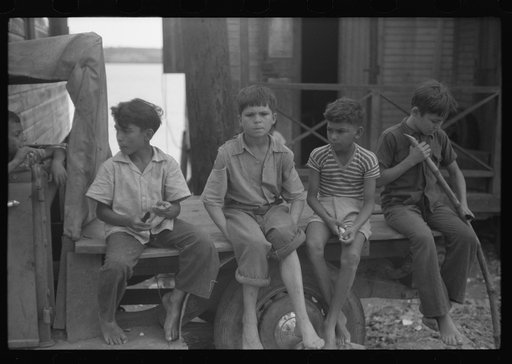Boys eating sugarcane in the small fishing village of Puerto Real, Puerto Rico