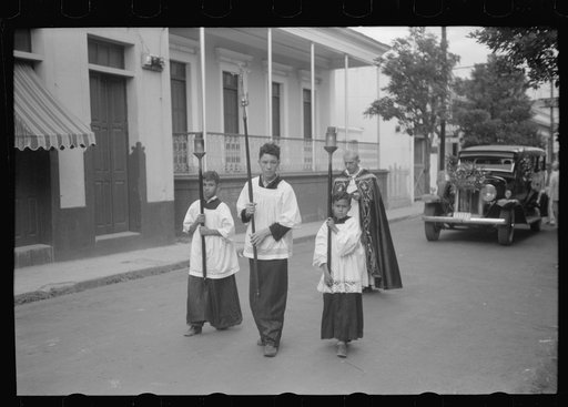 A funeral procession along the main street in Yauco, Puerto Rico