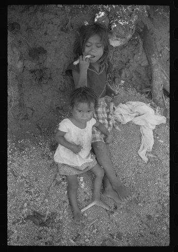 Farm laborer's children eating sugar cane in the hills near Yauco, Puerto Rico