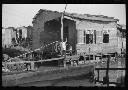 Untitled photo, possibly related to: Houses in the slum area known as "El Fangitto" (The Mud) in San Juan, Puerto Rico