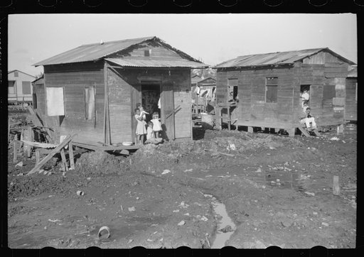 Untitled photo, possibly related to: Houses in the slum area known as "El Fangitto" (The Mud) in San Juan, Puerto Rico