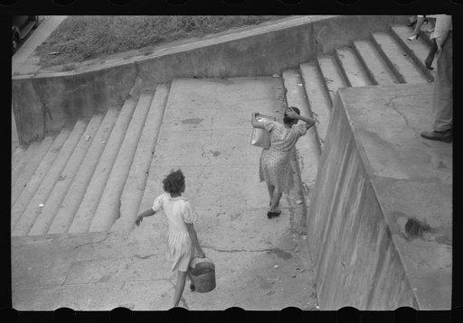 Untitled photo, possibly related to: San Juan, Puerto Rico. People carrying water home because of the failure of the water system for three days