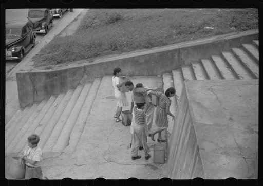 San Juan, Puerto Rico. People carrying water home because of the failure of the water system for three days