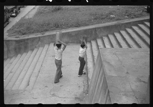 Untitled photo, possibly related to: San Juan, Puerto Rico. People carrying water home because of the failure of the water system for three days