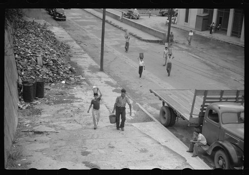 San Juan, Puerto Rico. People carrying water home because of the failure of the water system for three days