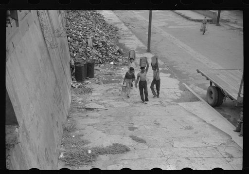 San Juan, Puerto Rico. People carrying water home because of the failure of the water system for three days