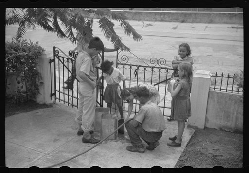 Untitled photo, possibly related to: San Juan, Puerto Rico. People carrying water home because of the failure of the water system in San Juan for three days
