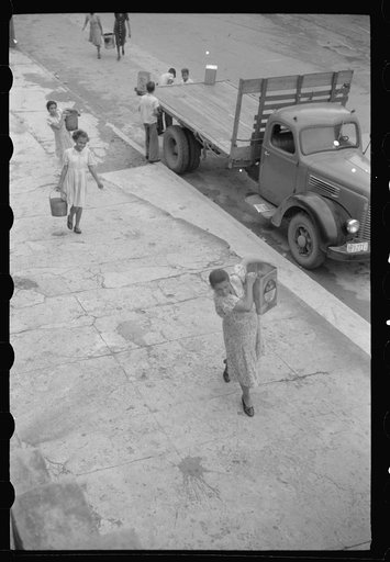 San Juan, Puerto Rico. People carrying water home because of the failure of the water system for three days